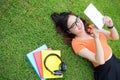Woman laying on the grass and using the tablet, Education concept, Technology concept Royalty Free Stock Photo