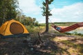 woman laying on hammock at camp near lake summer hiking concept Royalty Free Stock Photo