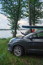 woman laying in hammock supboard on roof of car