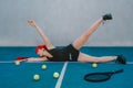 Woman laying in the tennis court with tennis balls near her Royalty Free Stock Photo