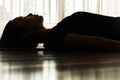 A woman laying on yoga mat relaxing. Meditation