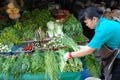 Woman lays grass for sale at a vegetable market