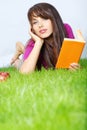 Woman lays on green field Royalty Free Stock Photo