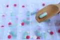 A woman lays many colorful tablets and capsules in a medicine box for use as daily medication. Royalty Free Stock Photo