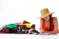 Woman lays near open suitcase.