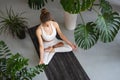 Woman leading a healthy lifestyle and practicing yoga, doing meditation, sitting in a lotus position with jnana mudra