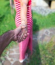 Woman leading a man outdoor giving her hand