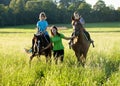 Woman Leading Two Horses with Boys