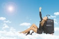 Woman leaned on luggage bags. Clouds, sky, sun as