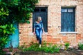 Woman leaning against a window of an old house. Royalty Free Stock Photo