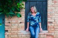 Woman leaning against a window of an old house. Royalty Free Stock Photo