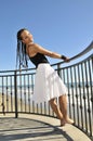 Woman leaning back on balcony smiling Royalty Free Stock Photo