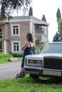 Woman Leaning on Old Limo Car over Big Mansion Royalty Free Stock Photo