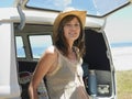 Woman Leaning On Open Tailgate Of Van