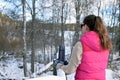 Woman leaning to snowy fence