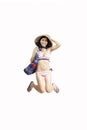 Woman leaping with bikini and beach items Royalty Free Stock Photo