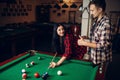 Woman learn to play billiard, poolroom Royalty Free Stock Photo