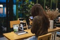 Woman is learning to use camera thru tutorial by laptop. Asian female watching online e-teaching training workshops for camera