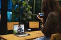 Asian female watching online training workshops for camera function by notebook in the living room