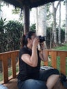 A woman learns to use a camera