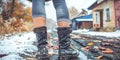 A woman in a leather coat with a belt and high heeled boots, demonstrating a stylish and eleg Royalty Free Stock Photo