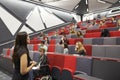 Woman lecturing students in a university lecture theatre Royalty Free Stock Photo