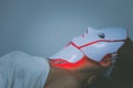 Woman with led light therapy facial and neck beauty mask photon therapy