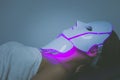 Woman with led light therapy facial and neck beauty mask photon therapy