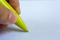 Woman left Hand holding a green pen, writing letter on white paper background, Notebook, Close up, Communication, Stationery