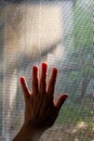 Woman left hand touching dust Dirty mosquito wire screen window, Light & Shadow shot, Silhouette, Close up shot