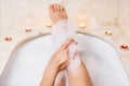 Woman legs in bath foam. Relaxation in spa