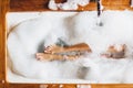 Woman legs in bath foam in spa hotel. Top view Royalty Free Stock Photo