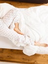 Woman legs on the bed in white bedclothes Royalty Free Stock Photo