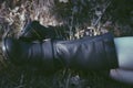 Woman legs in black leather boots on grass and autumn leaves. VS Royalty Free Stock Photo