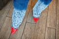 Woman legs in blue stylish jeans at and red high heels Royalty Free Stock Photo