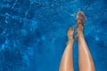 Woman legs in blue water swimming pool Royalty Free Stock Photo