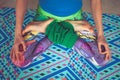 Woman legs in colorful leggings in lotus pose from above view in