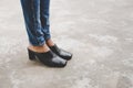 Woman legs in denim pants black stylish high heels shoes outdoo Royalty Free Stock Photo