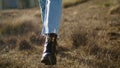 Woman legs going meadow closeup. Unrecognizable lady walking in autumn nature