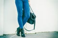 Woman legs in heels shoes handbag in hand Royalty Free Stock Photo