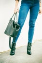 Woman legs in heels shoes handbag in hand Royalty Free Stock Photo