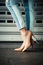 Woman legs in high heel shoes and blue jeans in city Royalty Free Stock Photo