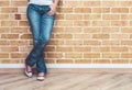 Woman legs in jeans and red sneakers Royalty Free Stock Photo