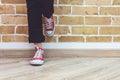 Woman legs in jeans and red sneakers Royalty Free Stock Photo