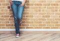 Woman legs in jeans and red sneakers Royalty Free Stock Photo