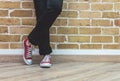 Woman legs in jeans and red sneakers Royalty Free Stock Photo