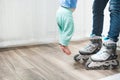 Woman legs in jeans in roller skate holding baby in air Royalty Free Stock Photo