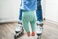 Woman legs in jeans in roller skate holding baby in air Royalty Free Stock Photo