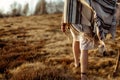 Woman legs in native indian american boho dress walking in windy Royalty Free Stock Photo