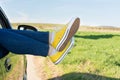 Woman legs out of the car window Royalty Free Stock Photo